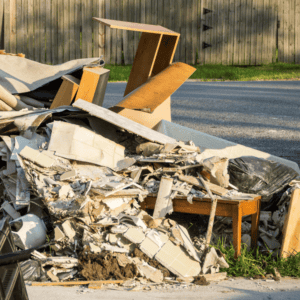 Pile of construction debris and discarded furniture roadside