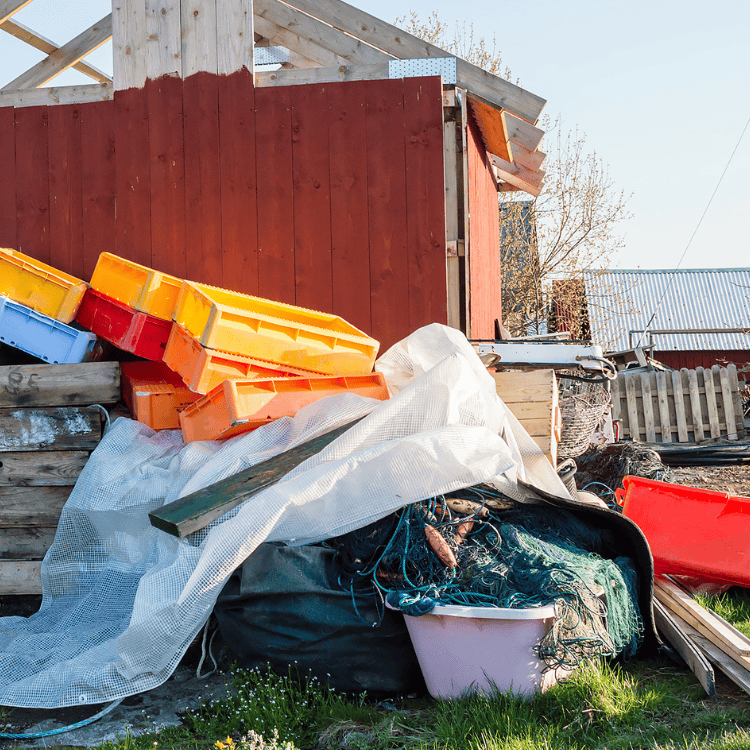 Cluttered outdoor area with colorful stacked fishing crates