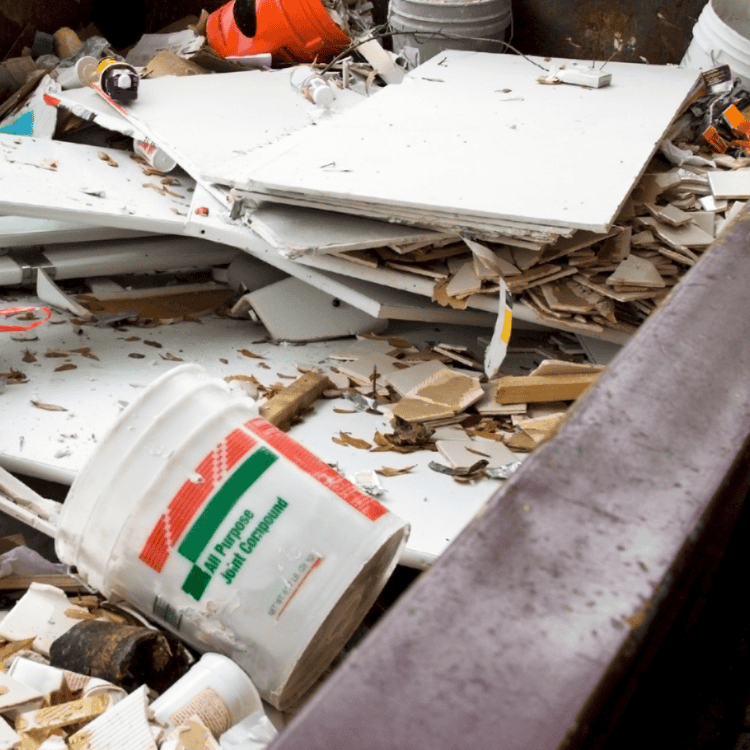 Overflowing construction waste dumpster with debris