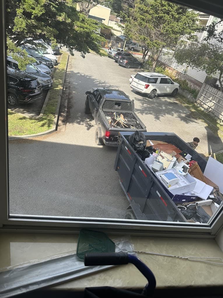 Truck loaded with debris, viewed from window above.