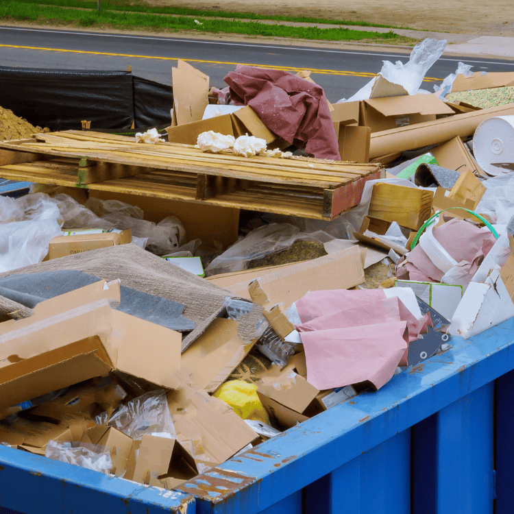 Overfilled dumpster with construction debris on roadside